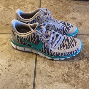 Nike gray/black and turquoise athletic shoes.